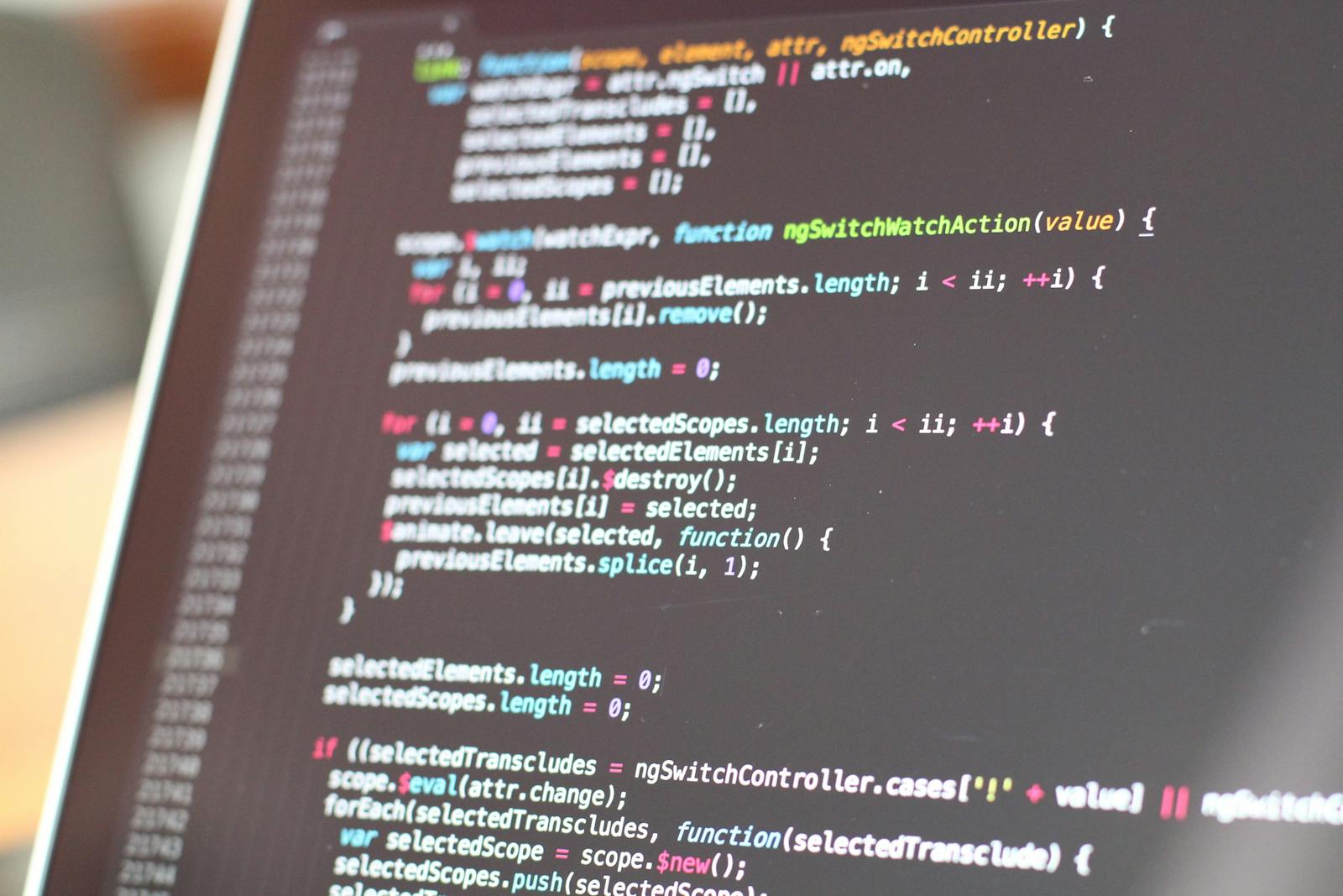 Production code on a developer monitor, dark IDE.